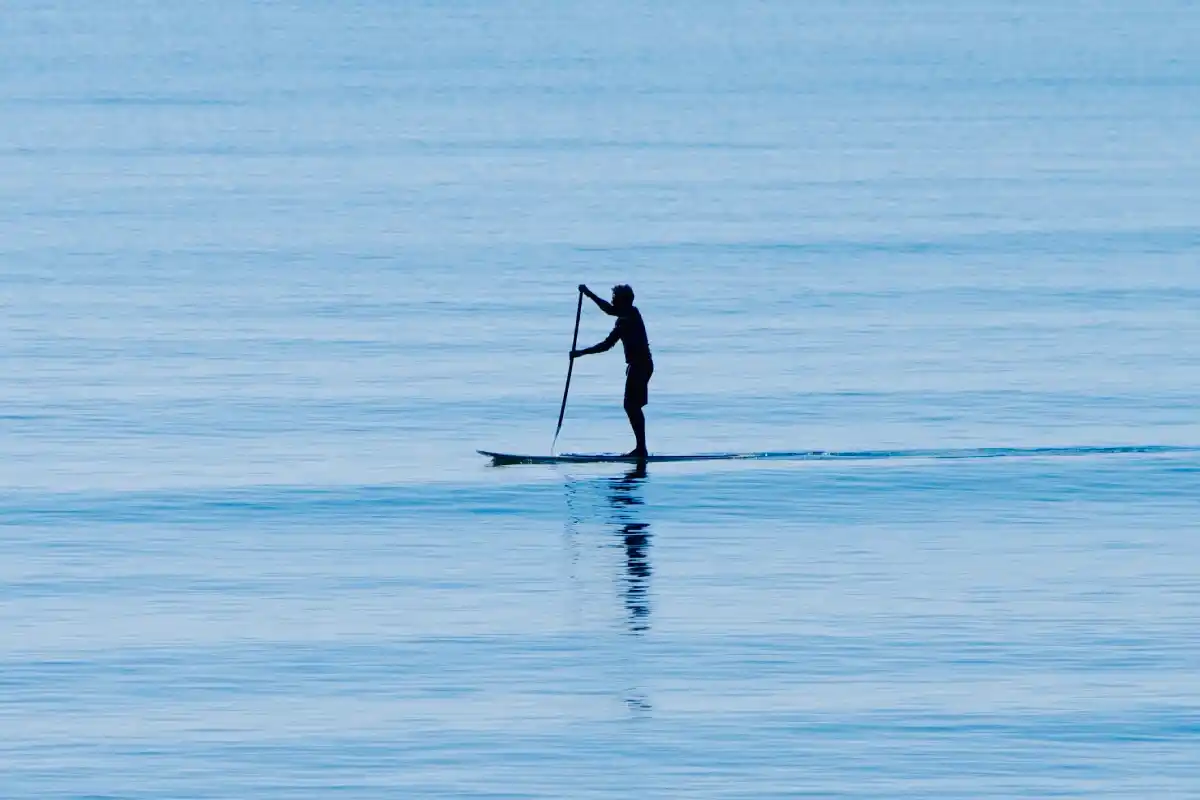 young man paddle boarding